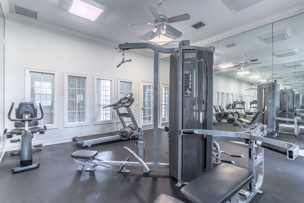 fitness center with equipment and mirror