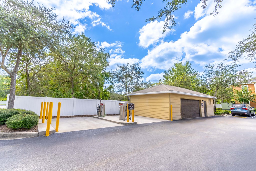a yellow garage with a car parked in front of it