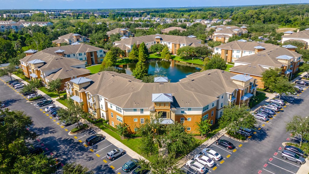an aerial view of a community with houses and a lake