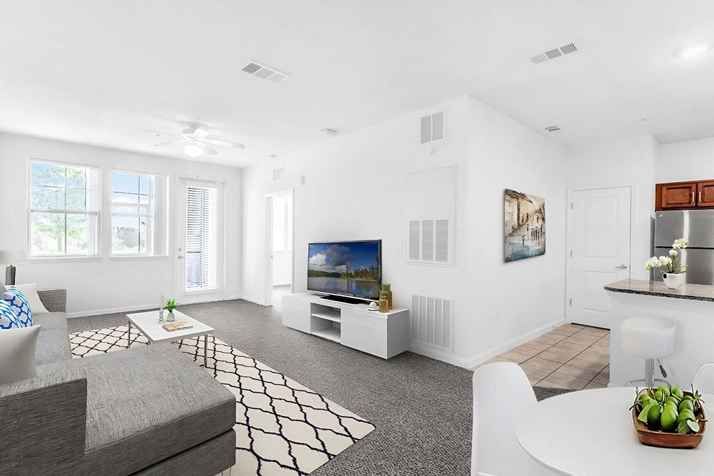 a living room with white walls and grey carpet
