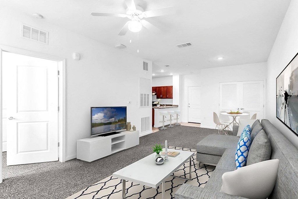 a living room with a gray couch and a white coffee table