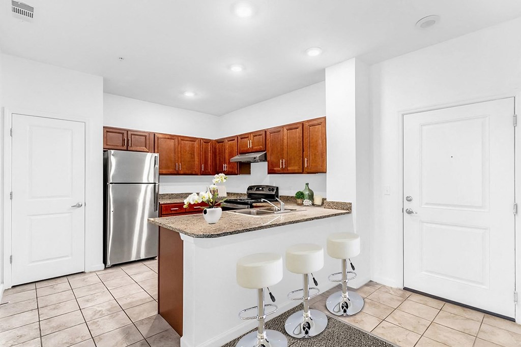 a kitchen with a breakfast bar and stainless steel appliances