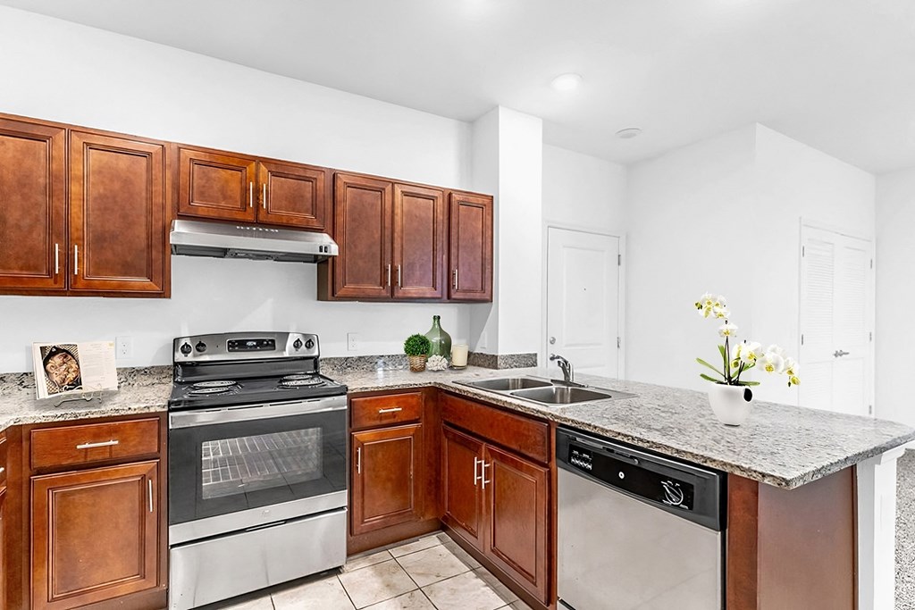 a kitchen with wood cabinets and stainless steel appliances
