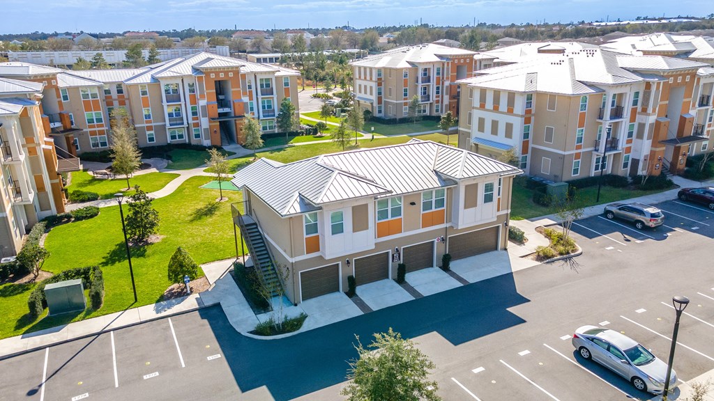 an aerial view of an apartment complex with a car parked in front of it