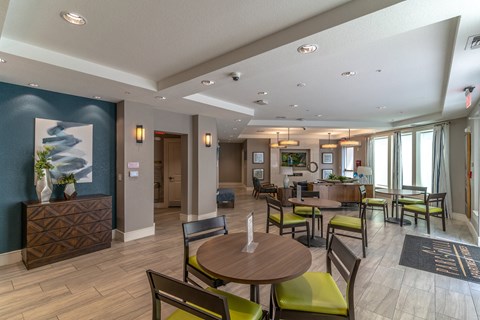 a resident clubhouse with tables and chairs