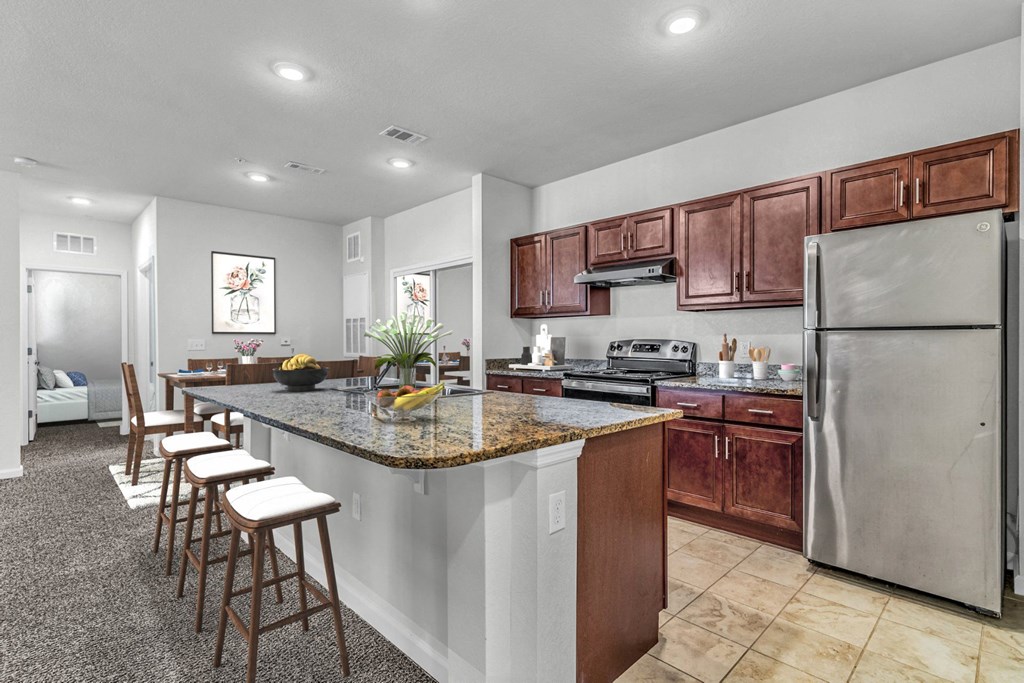 kitchen with barstools and dark cabinetry