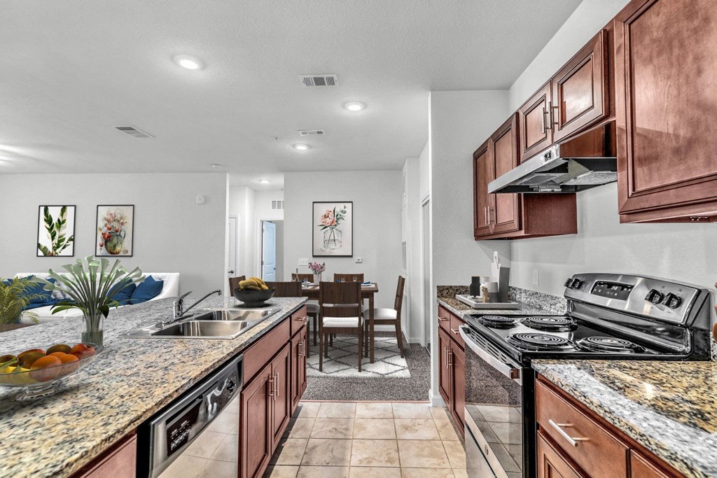 a kitchen with wooden cabinets and granite countertops