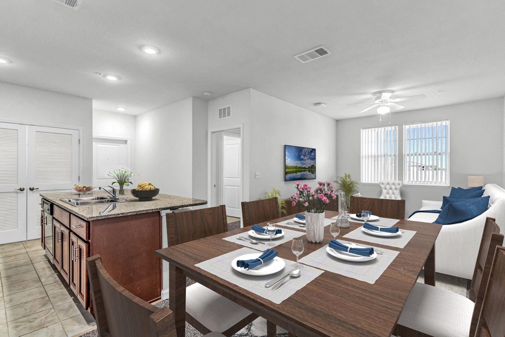 dining room with table and chairs with a kitchen and living room in the background