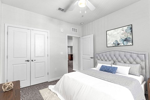 a bedroom with a bed and a ceiling fan