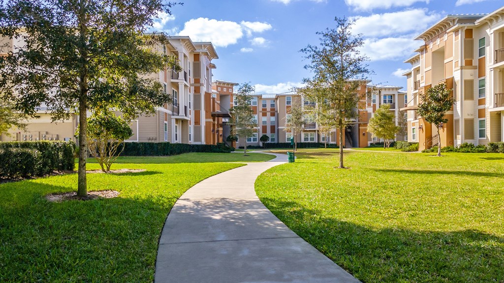 an exterior view of an apartment building on a sunny day