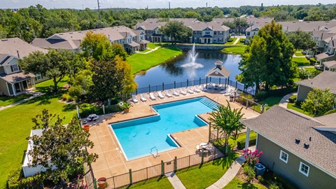 aerial view of pool, clubhouse and lake area
