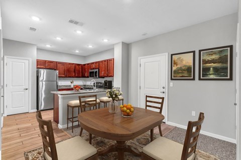 a kitchen and dining room with a table and chairs