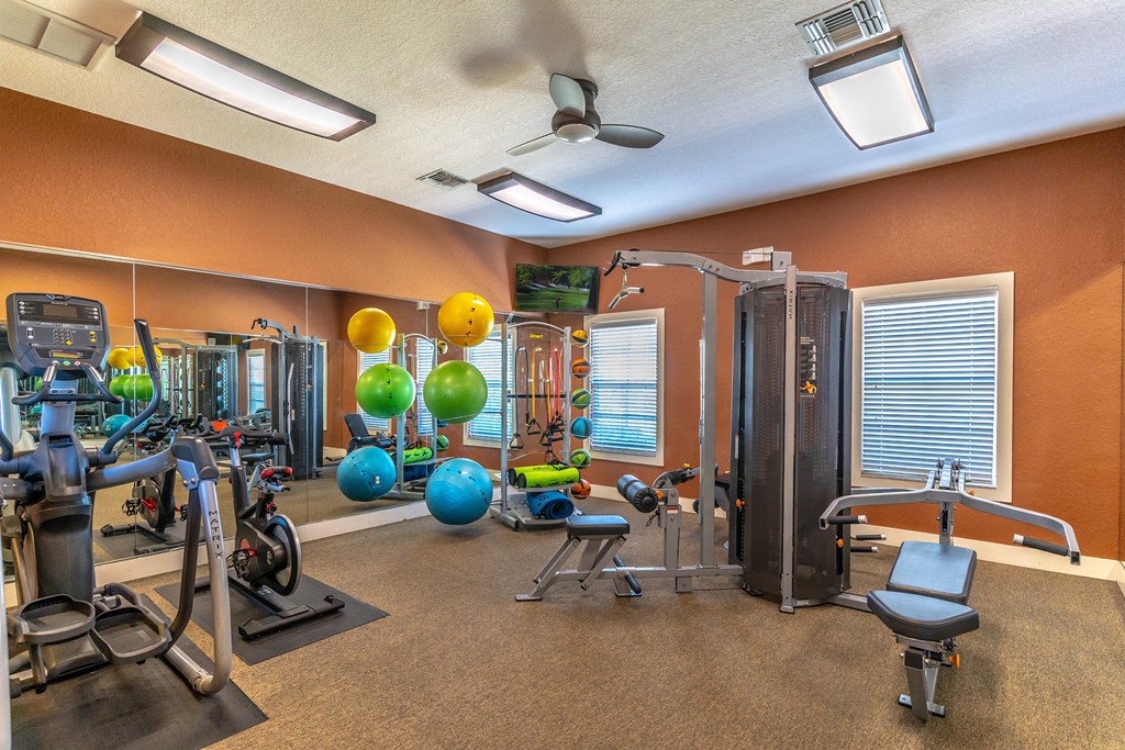 fitness center with equipment and mirror