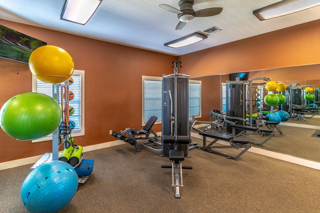 fitness center with equipment and mirror