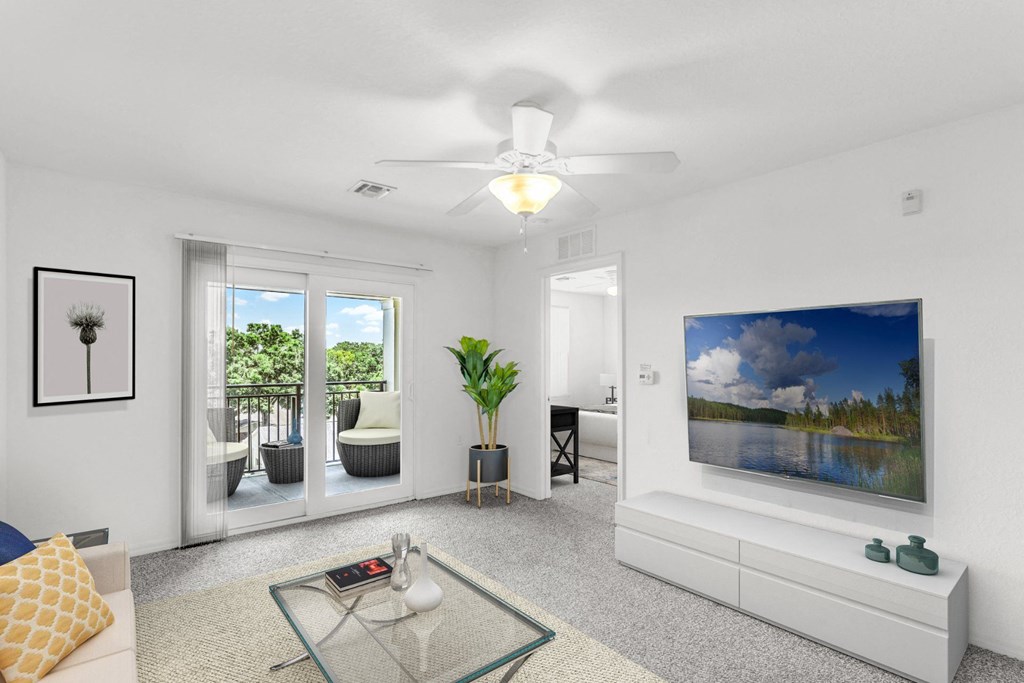 a living room with white walls and a white ceiling fan