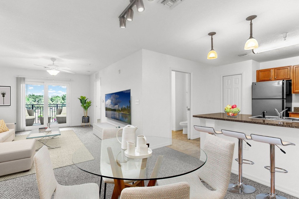 a living room with white walls and a glass table with white chairs