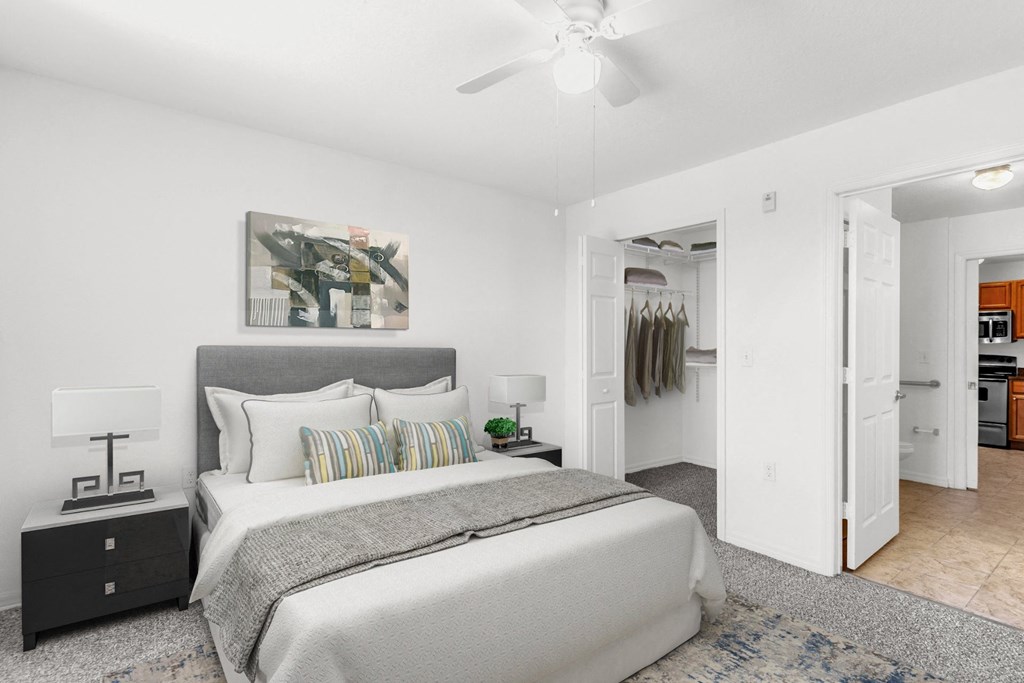 a bedroom with a bed and a ceiling fan