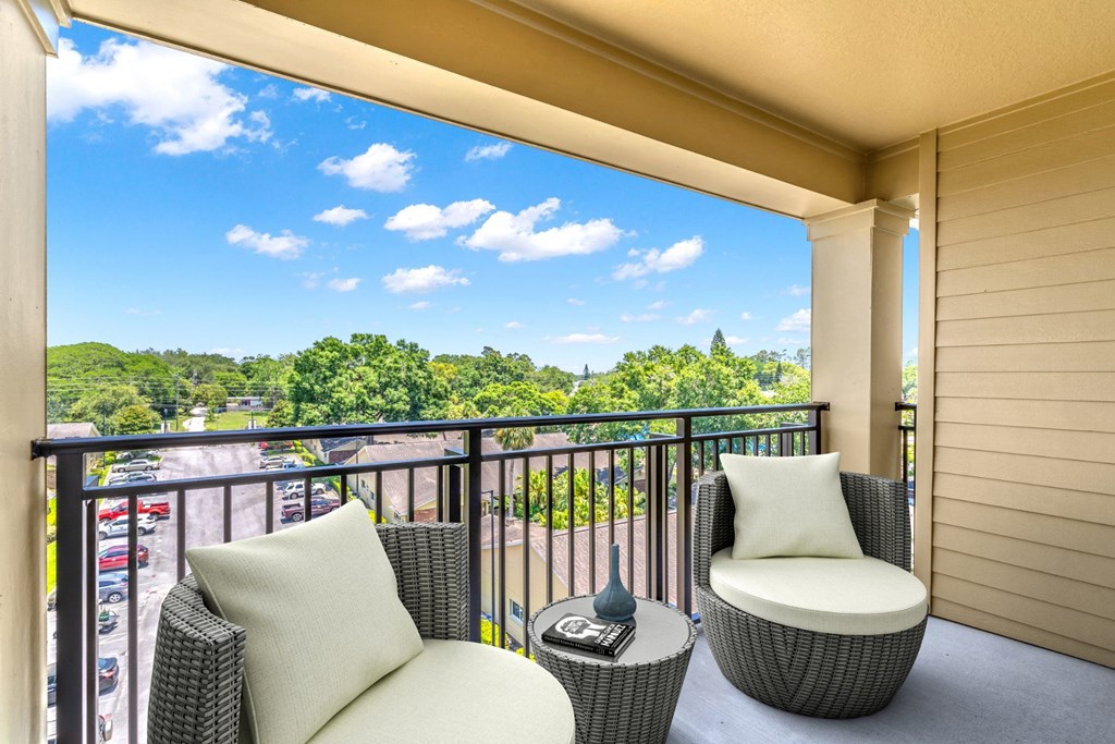 a balcony with two chairs and a table