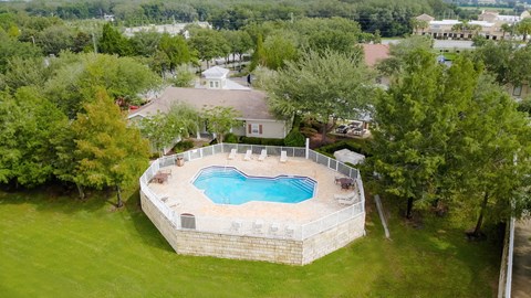 arial view of a swimming pool in the backyard of a house