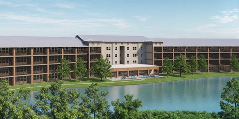 A large building with a pool in front of it.