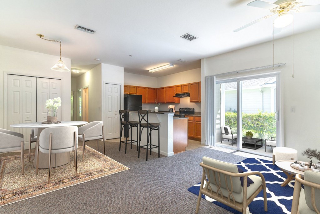 a living room and kitchen with a sliding glass door