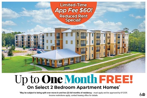 Apartment complex with a sign offering a free month on select 2 bedroom apartments.