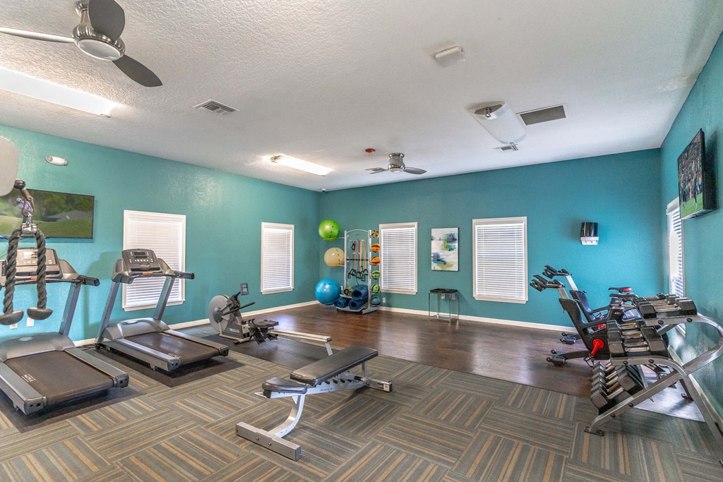 fitness center with equipment and mirror