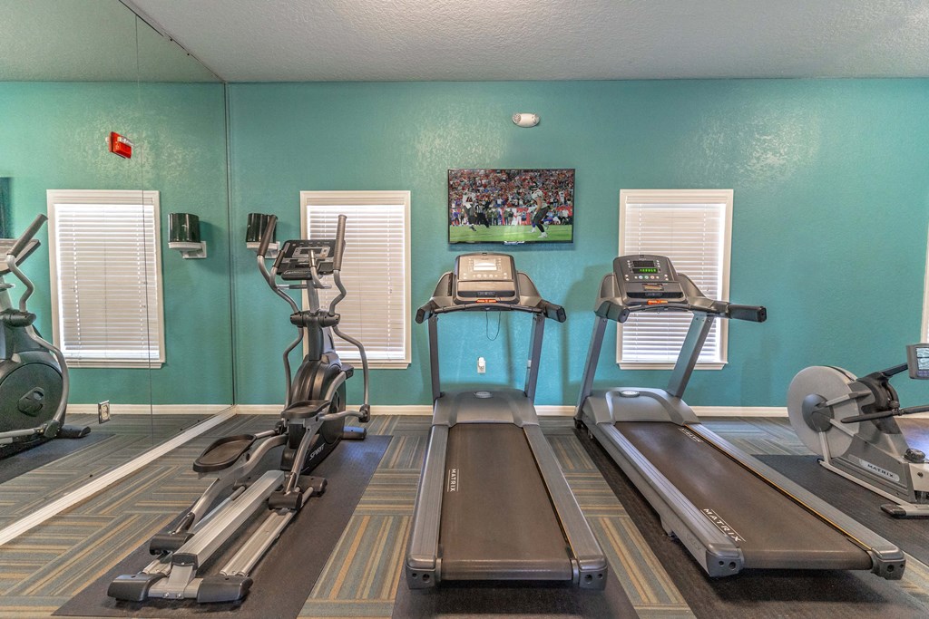 fitness center with equipment and mirror