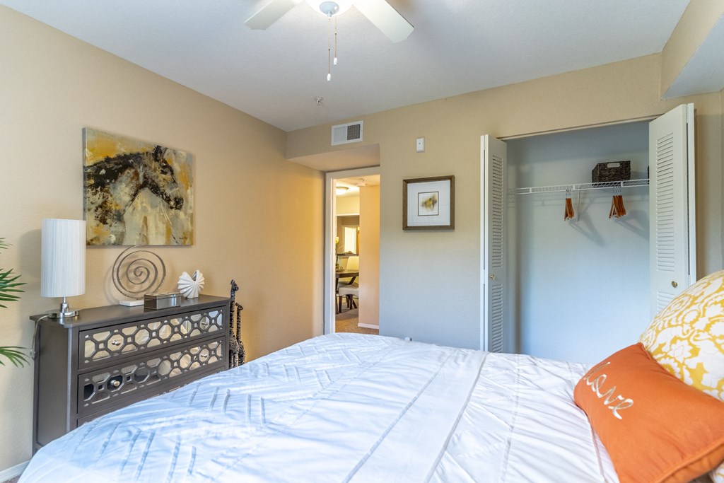 a bedroom with a large bed and a closet