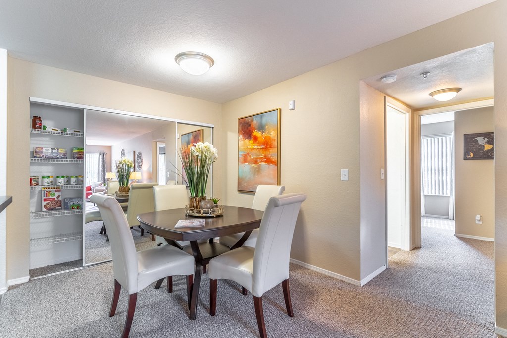 a dining area with a table and chairs