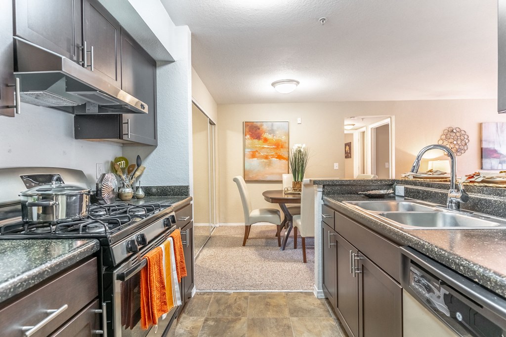 a kitchen with stainless steel appliances and granite countertops