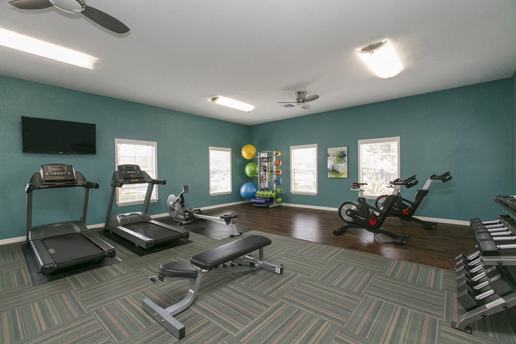 fitness center with equipment and mirror