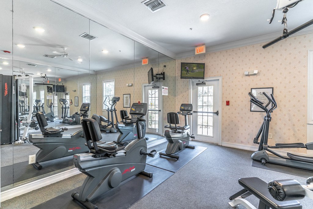 fitness center with equipment and mirror