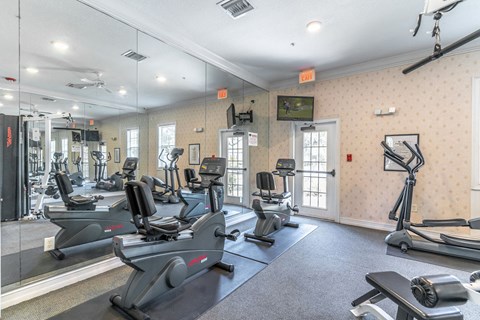 fitness center with equipment and mirror