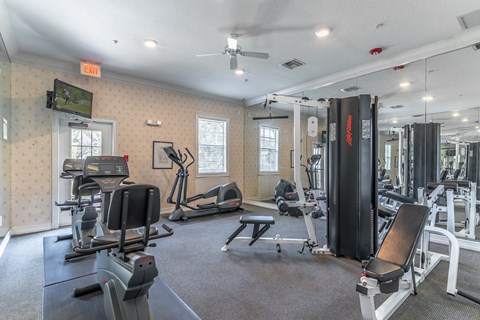 fitness center with equipment and mirror