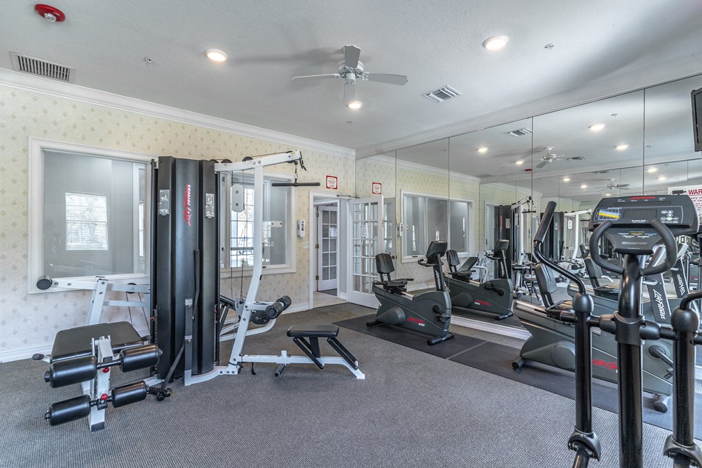 fitness center with equipment and mirror