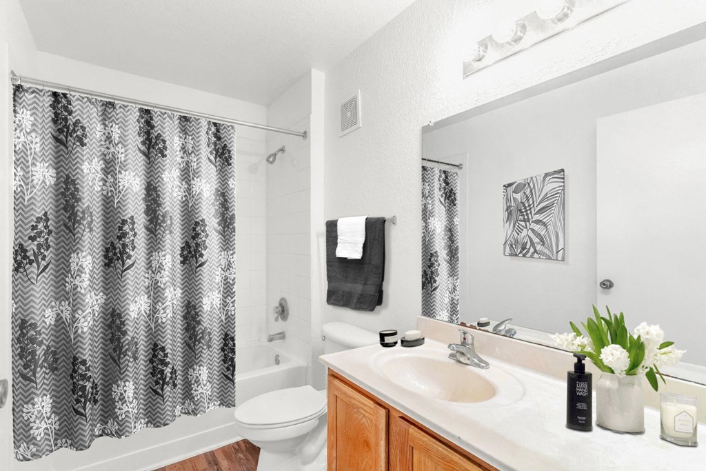 a bathroom with a sink toilet and shower