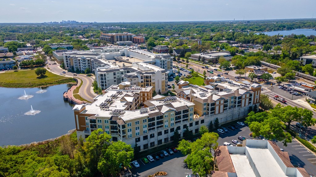 an aerial view of a large building next to a body of water