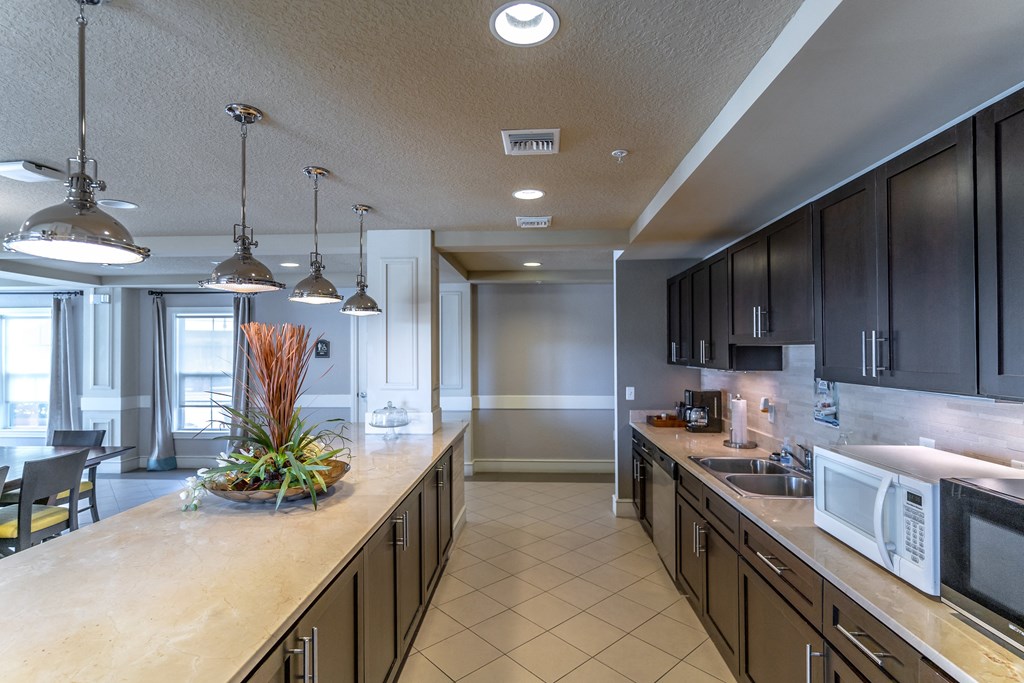 a kitchen with a long counter top and a sink