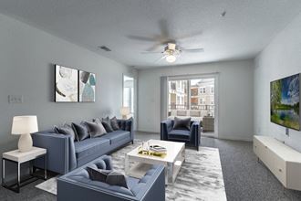 a living room with grey couches and a white coffee table