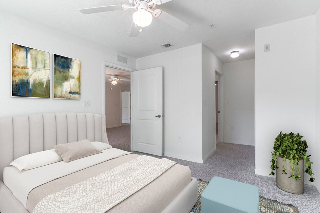 a bedroom with a white bed and white walls