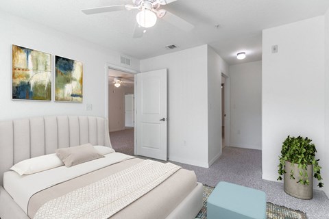 a bedroom with a white bed and white walls