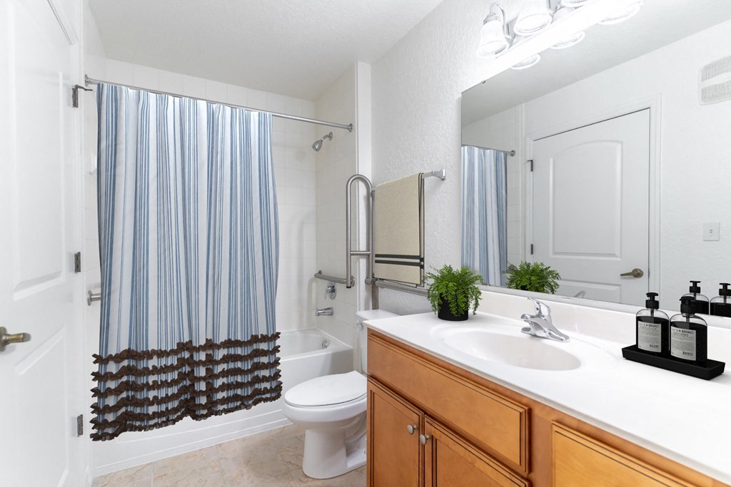 a bathroom with a shower toilet and sink