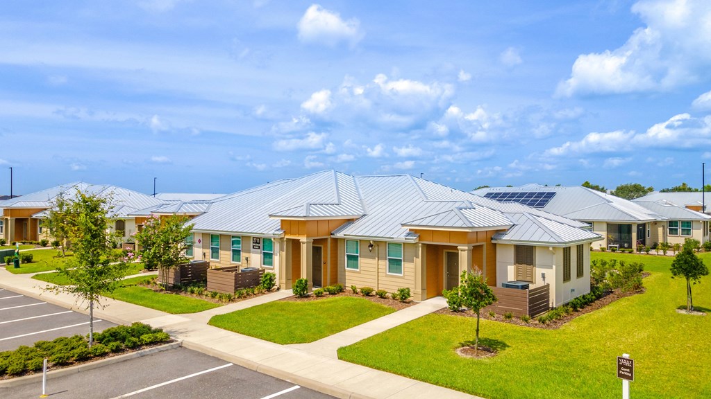a row of houses with solar panels on the roof