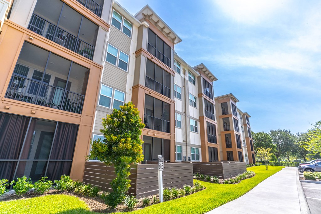 an exterior view of an apartment building on a sunny day