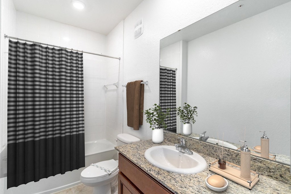 a bathroom with white walls and a black and white shower curtain
