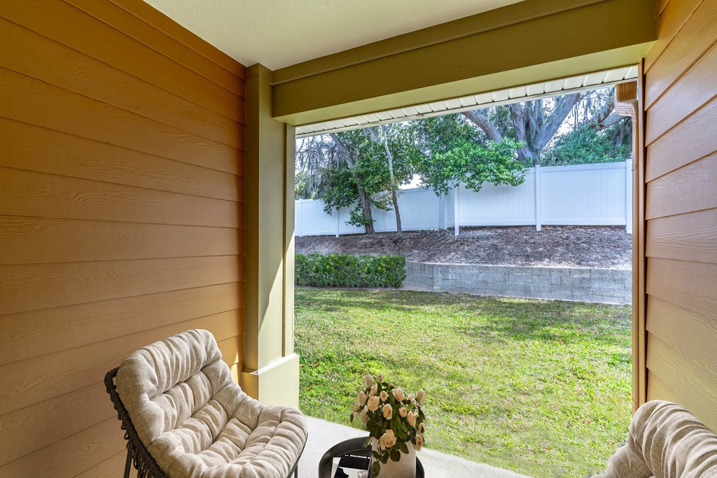 a living room with a large window overlooking a yard