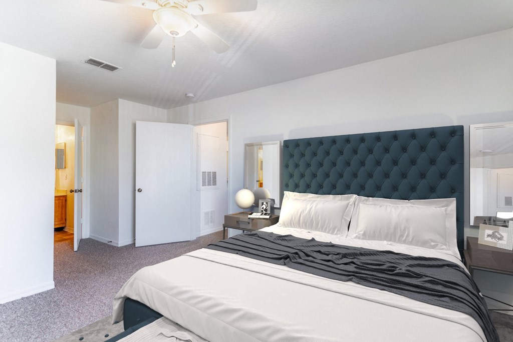 a bedroom with a large bed and a ceiling fan