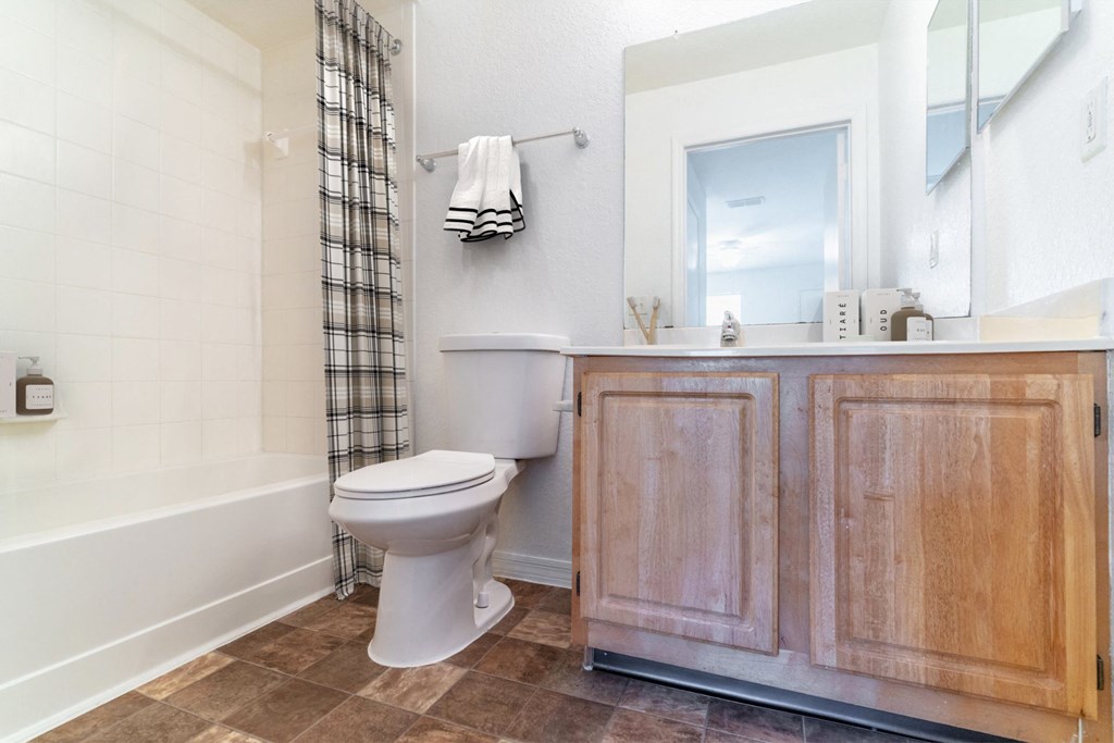 a bathroom with a toilet sink and bathtub