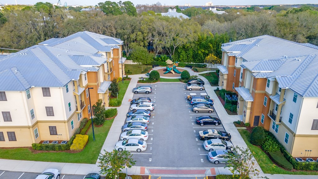 an aerial view of an apartment complex with a playground in the middle